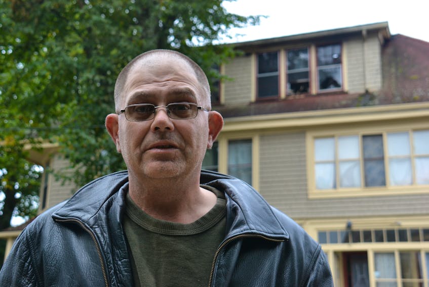 David Griffin feels lucky to have escaped a fire that happened at his apartment on Edward St. in Charlottetown late Saturday night. Shortly after discovering the fire, he passed out due to carbon dioxide poisoning near the building's front windows on the third floor, pictured behind him.
