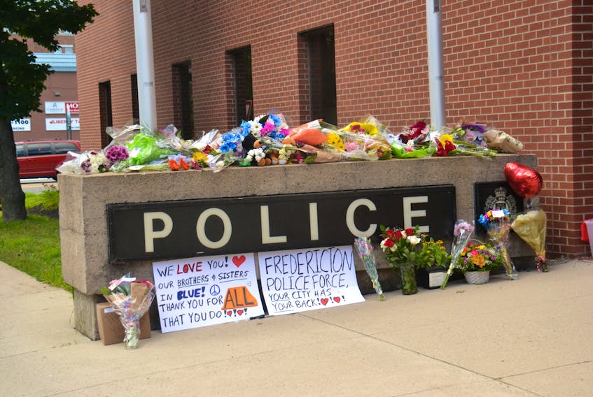 A monument set up by residents of Fredericton at the headquarters of the Fredericton Police Force on Friday afternoon. Four individuals, including two police officers have been confirmed dead after an early morning shooting in the New Brunswick capital.