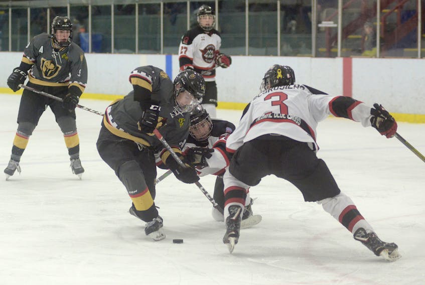 Moncton Flyers defenceman Matt Lint, centre, tries to slow down Charlottetown Bulk Carriers Knights forward Colby Huggan while Moncton blue-liner Jonathan Desrosiers prepares to make a hit Sunday during the New Brunswick/Prince Edward Island Major Midget Hockey League Showcase in Kensington.