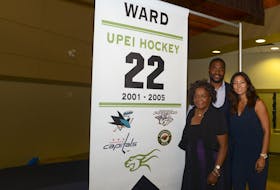 Joel Ward, his mother Cecilia and wife Kathleen at a ceremony in 2016 at UPEI where his No. 22 was honoured.