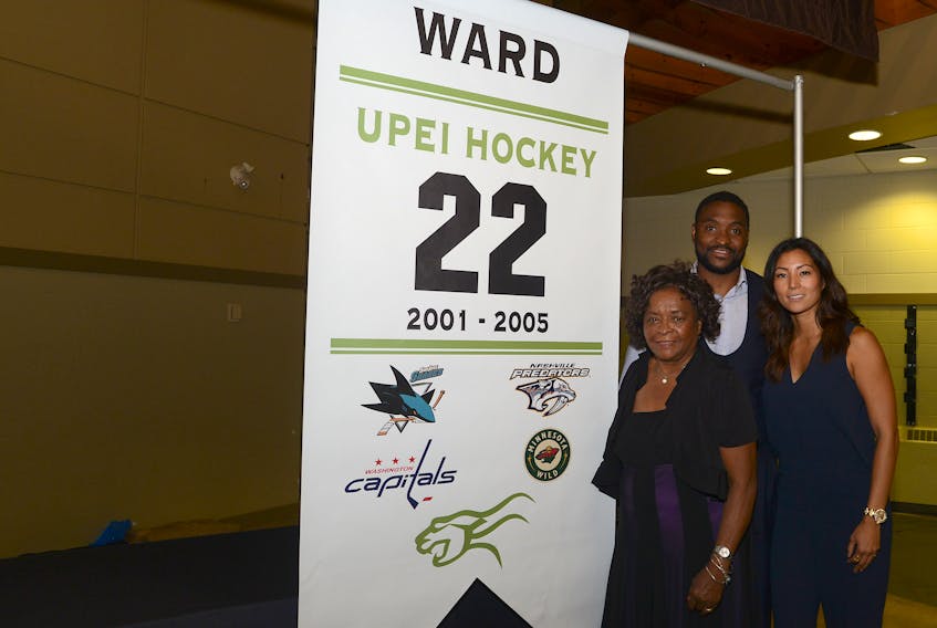Joel Ward, his mother Cecilia and wife Kathleen at a ceremony in 2016 at UPEI where his No. 22 was honoured.