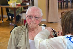 Art Johnstone, a resident of Charlottetown's Whisperwood Villa, is administered the Pfizer COVID-19 vaccine on Monday. Johnstone is the first resident of a long-term care facility to receive the vaccine.
