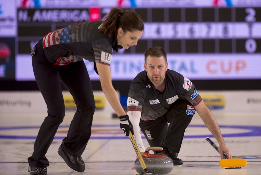 Lisa Weagle begins sweeping a rock thrown by Brad Gushue during their mixed doubles game at the Continental Cup curling competition in London Ont., on Thursday. Gushue teamed with Weagle to defeat Oskar Eriksson and Anna Hasselborg of Sweden 7-3. The Continental Cup sees players representing North America take on those from the rest of the world in regular-format curling games, mixed doubles and skins games. In a Thursday evening draw, Gushue and his regular teammates — Mark Nichols, Brett Gallant and Geoff Walker — downed Peter de Cruz of Switzerland 7-2. — Michael Burns photo