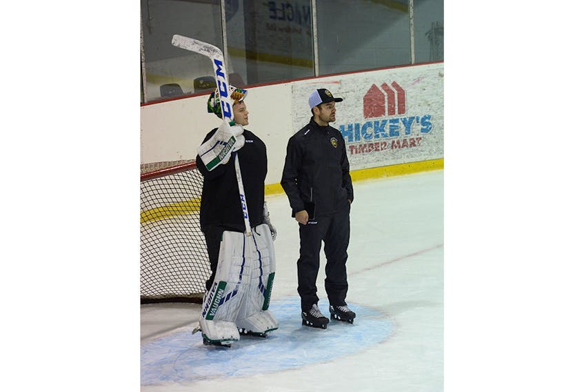 Newfoundland Growlers goaltender Mike Garteig, shown here chatting with goalie coach Marek Benda, skated with the team Wednesday before hitting the road for a bus trip across the island, Garteig’s second in less than a week.