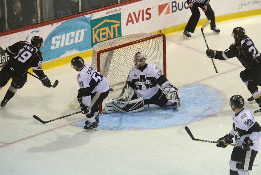 Charlottetown Islanders forward Cam Askew, left, beats Blainville-Boisbriand Armada goalie Emile Samson for the overtime winner Sunday at the Eastlink Centre to force Game 7 Tuesday in Boisbriand, Que.