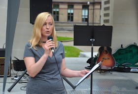 Chelsea Sawatzky of the Lower Power Rates Alliance leads a rally at Parade Square in downtown Halifax on Saturday afternoon.