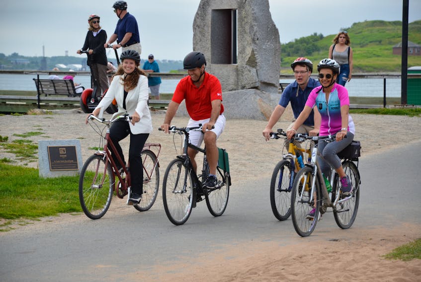 From left to right, Kelsey Lane, Halifax MP Andy Fillmore, Coun. Sam Austin and MLA Rafah DiCostanzo bike along the Halifax waterfront on Monday morning.   The three levels of government committed a combined total of $25 million to complete a 30-kilometre system of bicycle and pedestrian pathways on both sides of the harbour.