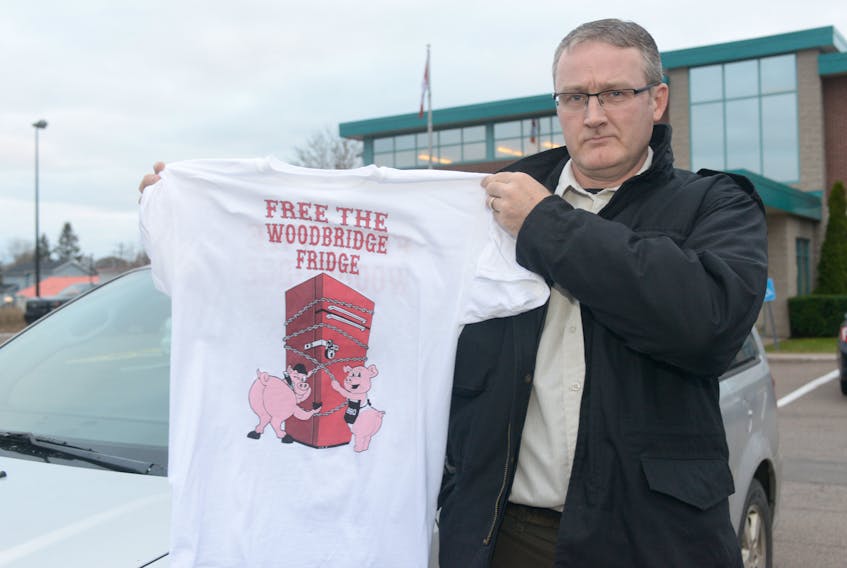 RCMP Cpl. Andy Cook holds a Woodbridge Hells Angels hangaround club shirt, which he said shows clear disdain for law enforcement. The shirt makes reference to the P.E.I. group’s fridge being seized by police under the liquor control act last April, which was before members of the club began wearing prospect patches. MITCH MACDONALD/THE GUARDIAN
