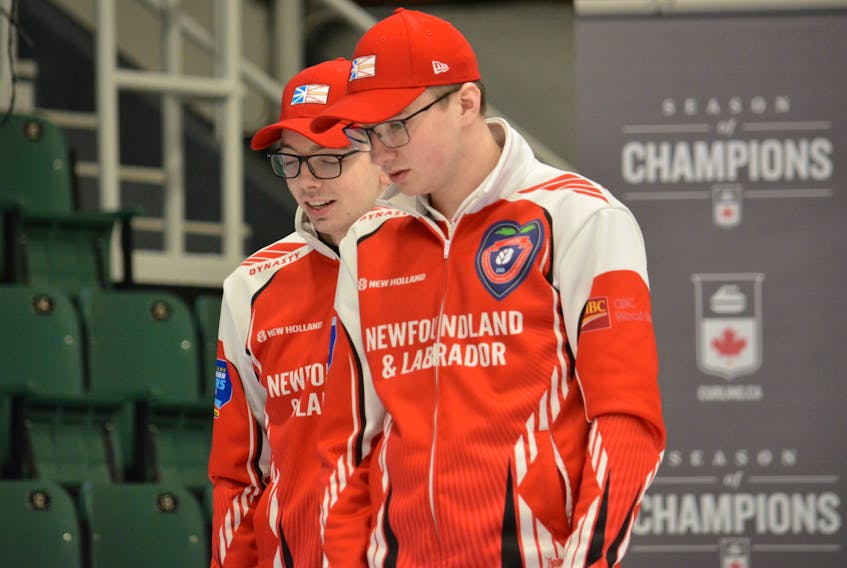Newfoundland and Labrador skip Daniel Bruce and second Joel Krats consider a shot during a game at the Canadian junior men's curling championship in Langley, B.C. Bruce, Krats and teammates Ryan McNeil Lamswood and Nathan King will face Saskatchewan in the championship semifinal 3:30 p.m. NT today. — Curling Canada photo