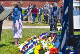 Kristen Brann, 14, takes a moment to look at all the wreaths laid for fallen coal miners who died due to workplace injuries during the Davis Day ceremony at the Miners’ Museum in Glace Bay on June 11. The Grade 9 Glace Bay High student was one of the students from Raylene Nicholson’s citizenship class who raised $1,000 for the Miners’ Memorial Park, which was unveiled the same day. Money was donated to help with phase two of the park construction — a monument in memory of the 12 men who died because of the 1979 explosion at No. 26. Brann and classmates each placed a single rose in memory of each of the men.
