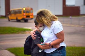 Davis MacLeod, a Grade 5 student at Stratford Elementary School, hugs his mother Sara MacLeod goodbye Tuesday morning. For many students Tuesday was the first day of the new school year and the first time most students have been physically in class since the beginning of the coronavirus (COVID-19 strain) pandemic in mid-March.