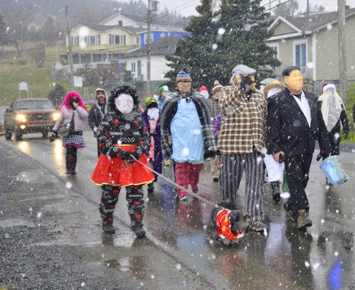 Cosmetic Snow for the mummers…
It was the first snowfall of the season and a great day for mummers to dance and sing in the annual Mummers Parade in Dildo, Trinity Bay NL.  Marilyn Crotty snapped this great photo of a group of somewhat shady looking characters.  I’m told there’s no right or wrong way to dress up, but concealing your identity is the mark of an experienced mummer.  
No word on whether Marilyn found her inner mummer on Saturday.