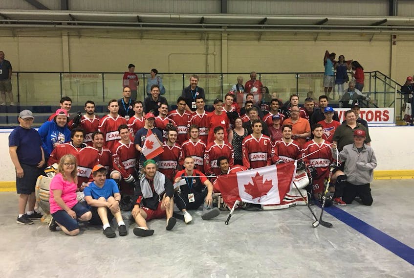 Members of the Vera Perlin Society in St. John's pose with members of the Canadian under-20 ball hockey team after taking in one of Canada's games at the world junior ball hockey championships in Mount Pearl. The Canadian U20s will face Slovakia in a semifinal at 6 p.m. today at the Glacier. Meanwhile, Canada's U-18 entry has earned a berth in the gold-medal game in that division. — Submitted