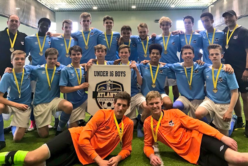 Newfoundland and Labrador players and coaches pose with the championship banner and their gold medals after winning the final of the Atlantic boys U16 soccer tournament in Halifax on Sunday. The team beat P.E.I. 3-2 in a gold-medal contest decided by penalty kicks. The result meant they finished the event with four victories in as many games. — Twitter/Soccer Nova Scotia