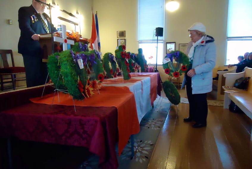 Leoda Varner lays a wreath in memory of her three brothers, Austin, Carson and Hubert Yorke during Remembrance Day services Nov. 10 at the Diligent River Baptist Church.