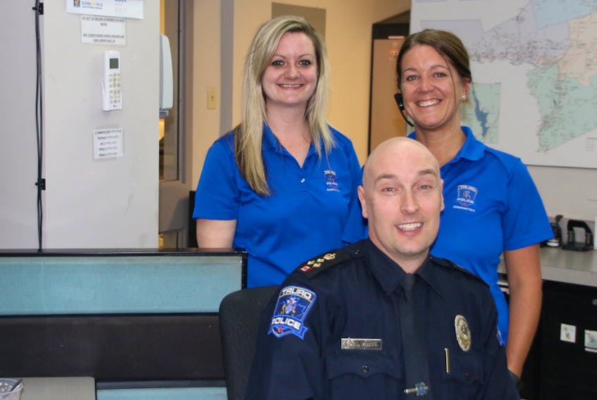 Truro Police Chief Dave MacNeil is happy to have people like Candace Chornoby, left, and Erin Adams behind him. The women have been dispatchers with the service for several years.