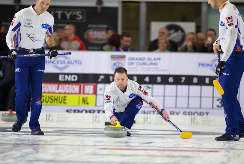 Anil Mungal/World Curling Tour — Brad Gushue delivers a stone as his front end of Geoff Walker, left, and Brett Gallant prepare to sweep in their first game at the Princess Auto Elite 10 in Chatham, Ont. Wednesday.