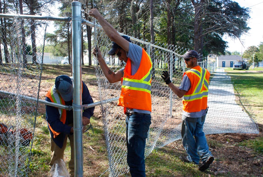Crews from Eastern Fence work on erecting fencing for Amherst's new dog park at Dickey Park. The park is set to open during next weekend's A-Fest. - Town of Amherst photo.