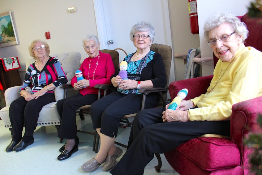 Four women who started knitting as young girls including Helen Crooks, from right, Lois Turner, Mildred Huntington and Mary Ann Troke recently completed dozens of Izzy dolls to be given to children in areas of conflict around the world.