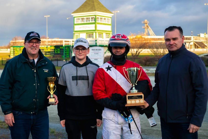 David Dowling won the Paul MacDonald Memorial Driving Championship Saturday at Red Shores at the Charlottetown Driving Park. From left are Peter Smith, P.E.I. Standardbred Horse Owners Association president; MacDonald’s grandson Devin, Dowling and MacDonald’s son Danny. Stephanie Mitchell/Red Shores/Special to The Guardian