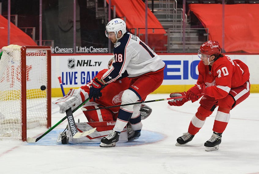 Columbus Blue Jackets centre Pierre-Luc Dubois scores against Detroit Red Wings goaltender Thomas Greiss as defenceman Troy Stecher tries to stick check during the third period of an NHL game Monday in Detroit. - Tim Fuller / USA Today Sports