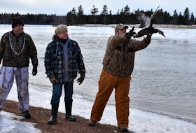 Kevin Arsenault, left, of the Delta Waterfowl P.E.I. chapter, joins Kate MacQuarrie, chairwoman of the Women Shooters of P.E.I., and Eric Paynter, Delta Waterfowl of P.E.I. chairman, to work together to band and release waterfowl during an event in Wellington recently. Delta Waterfowl teamed up with the Women Shooters of P.E.I. as part of a long-term effort to track migratory birds and determine the health of their population.