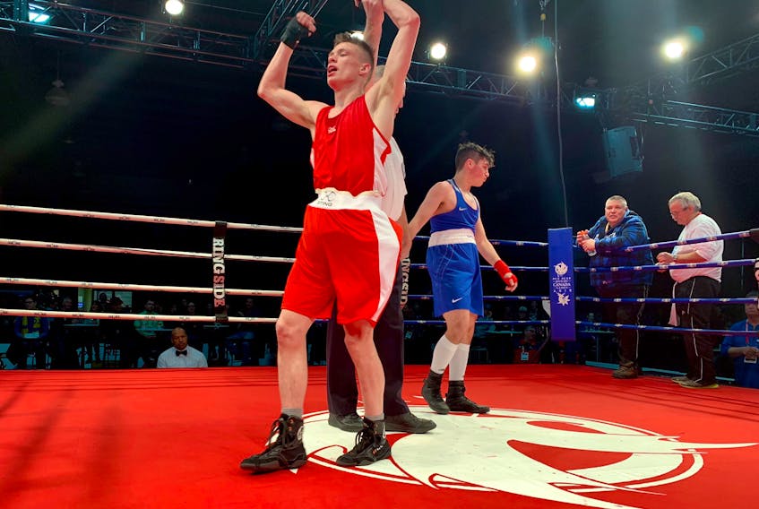 Newfoundland and Labrador's Nick Callahan (left) celebrates after defeating Alberta's Fausto Santoro in their 64-kilogram boxing matchup at the Canada Winter Games in Red Deer, Alta., Monday night. Callahan had trailed on all five judges' cards after the first round, but rallied for a 4-1 decision in the three-round bout. — Boxing Canada/via TeamNL/Twitter