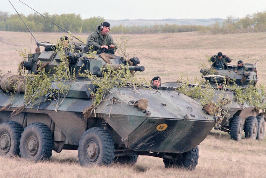 A pair of Canadian army Cougar vehicles ride through a field during a military exercise at Camp Wainwright, Alta. in the 1980s.  SPECIALIST 5 VINCE E. WARNER/DEFENSEIMAGERY.MIL