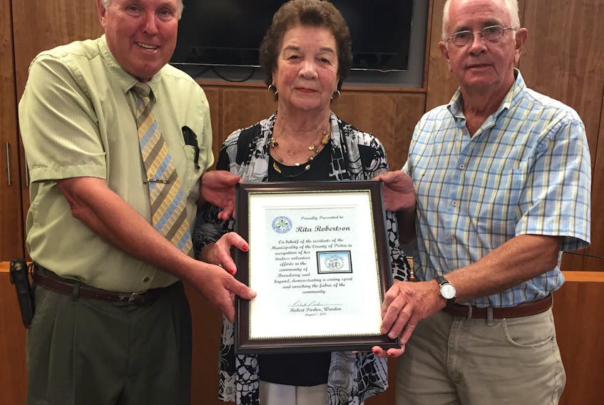 Rita Robertson of Broadway accepts a plaque of appreciation from Pictou County Warden Robert Parker, left, and Coun. Don Butler during a recent county council meeting.
