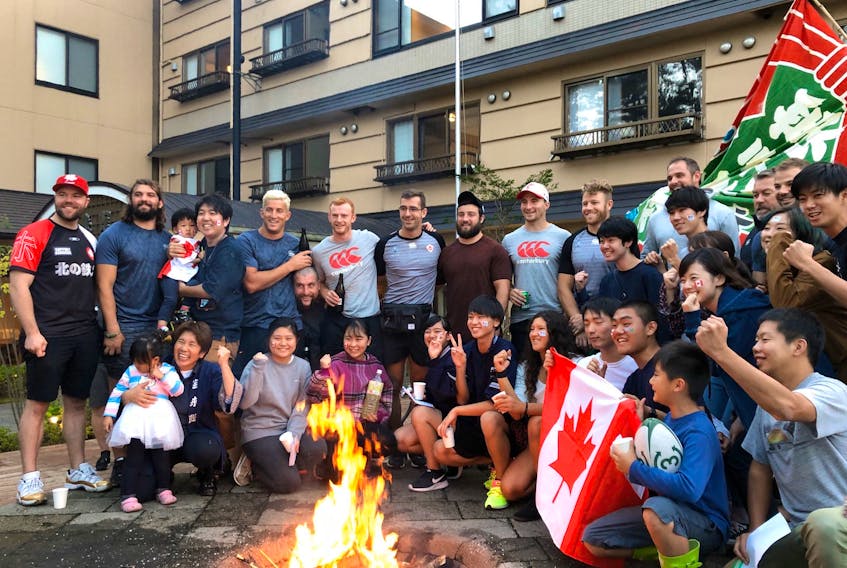 Canadian rugby players, including St. John's native Patrick Parfrey (top row, sixth from left), gather with residents of the Japanese community of Kamaishi after helping in the cleanup after Typhoon Hagibis hit the area over the weekend. Because of the storm, Canada's final match at the Rugby World Cup was cancelled. — Rugby Canada/Twitter