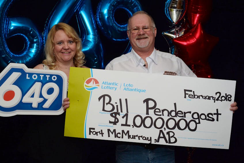 Bill Pendergast and his wife Carrie accept a cheque for $1 million at Atlantic Canada Lotto headquarters in St. John's Friday.