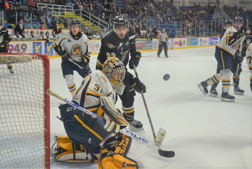 Shawn Boudrias of the Cape Breton Eagles watches the puck as goaltender Antoine Coulombe of the Shawinigan Cataractes prepares to make a save during Quebec Major Junior Hockey League action at Centre 200 on Thursday.