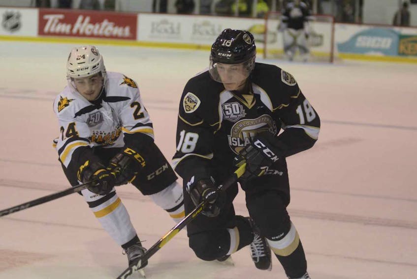 Cape Breton Screaming Eagles right-winger Ryan Francis, left, tries to knock the puck away from Charlottetown Islanders defenceman Alexander Dersch during Friday's opening game of the Quebec Major Junior Hockey League regular season for both clubs.
