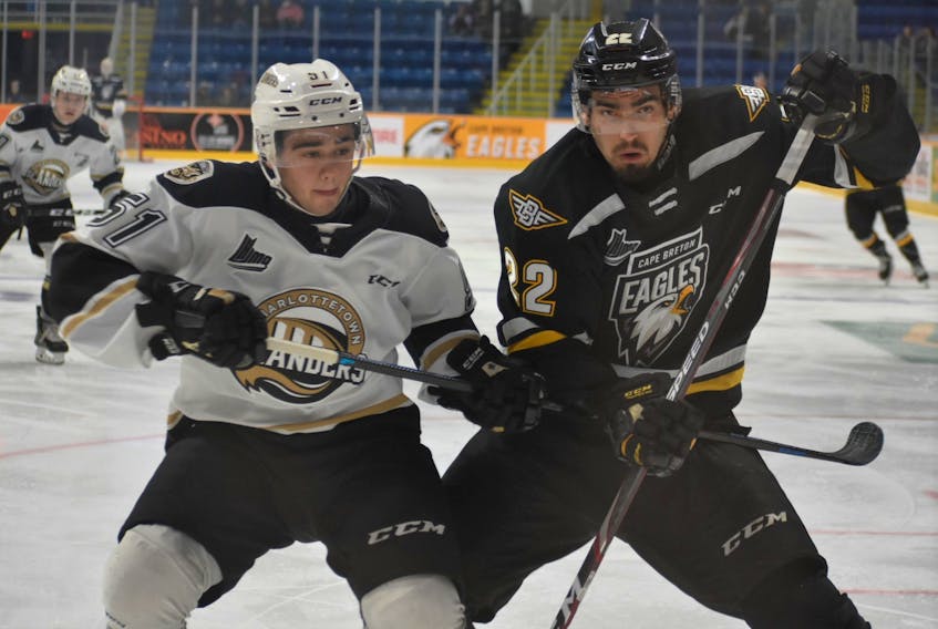 Shawn Boudrias of the Cape Breton Eagles, right, and Lukas Cormier of the Charlottetown Islanders battle for possession during Quebec Major Junior Hockey League action at Centre 200 on Wednesday.