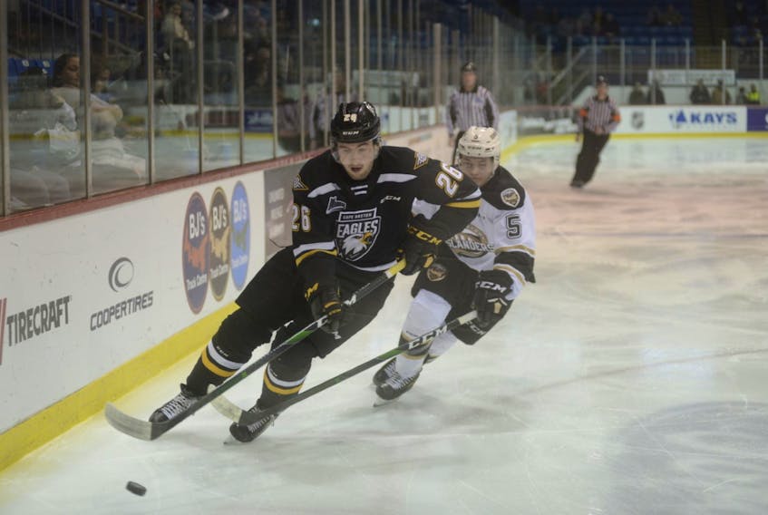 Egor Sokolov of the Cape Breton Eagles, left, carries the puck in the offensive zone as Anthony Hamel of the Charlottetown Islanders follows during Quebec Major Junior Hockey League action at the Eastlink Centre in Charlottetown on Friday. Cape Breton won the game 5-2.