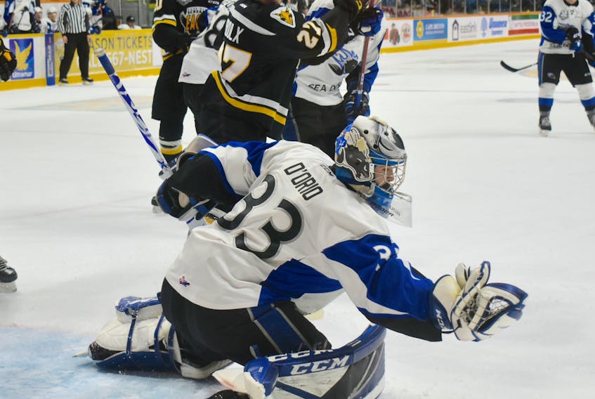 Alex D’Orio of the Saint John Sea Dogs, right, makes a glove save as Gabriel Proulx, middle, battles with Michael Campoli of the Sea Dogs in front of the net during Quebec Major Junior Hockey League action at Centre 200 on Wednesday. Cape Breton won the game 6-2.