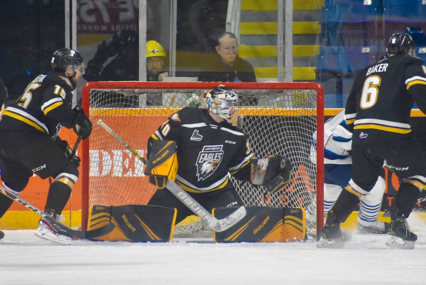 Cape Breton Eagles goalie William Grimard spreads out across his net while flanked by defencemen Kyle Havlena, left, and Jarrett Baker during first period action against the Chicoutimi Saguenéens at Centre 200 on Sunday. Chicoutimi won the game 2-1.