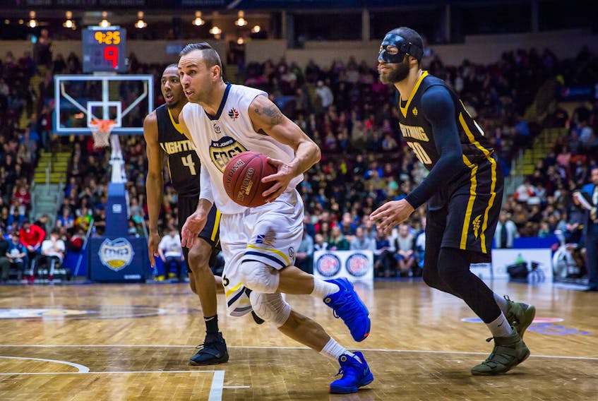 In this March 10 file photo, Carl English (left) of the St. John’s Edge moves the ball against Royce White (30) and the London Lightning during an NBL Canada game at Mile One Centre in St. John’s. The upcoming Central Division playoff semifinal between the Edge and Lightning will feature the league’s two most recent MVPs — White in 2017 and English this season. White and English, respectively, were also the NBLC’s leading scorers in 2017-18. — St. John’s Edge photo/Jeff Parsons