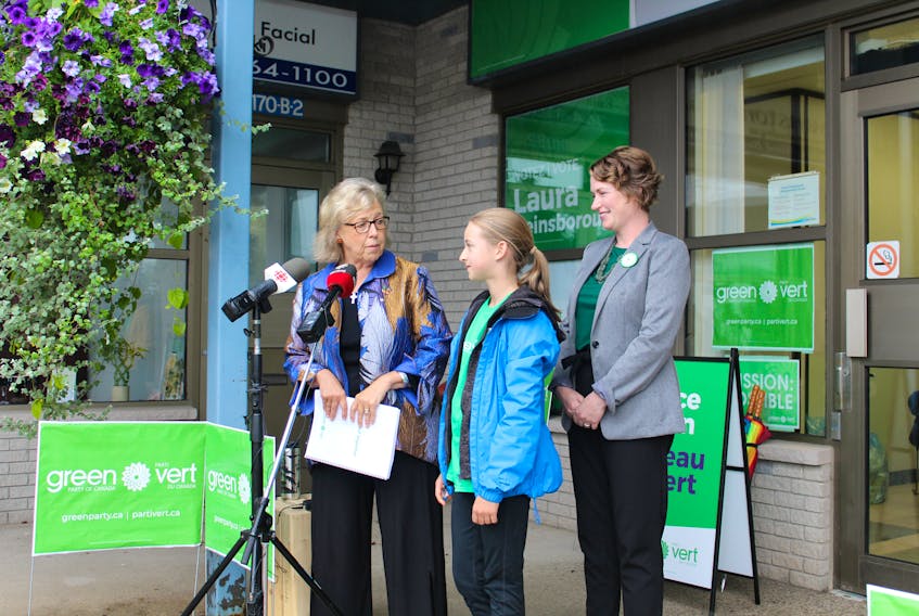 Federal Green Party leader Elizabeth May chats with 14-year-old Quinn MacAskill, a member of the Sackville Youth Climate Change Coalition, during a visit to Sackville on Tuesday, where May campaigned with Beausejour candidate Laura Reinsborough, right.