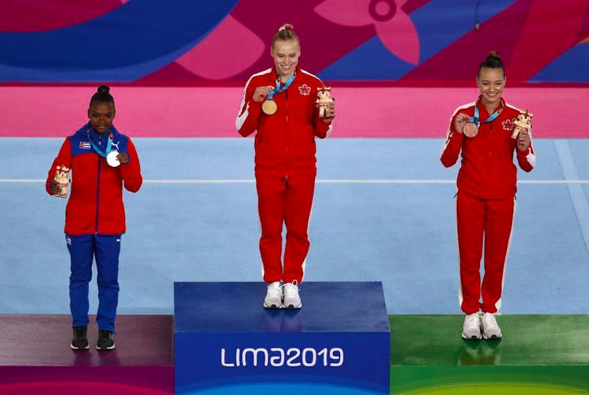 Gold medalist Ellie Black of Canada, silver medalist Yesenia Ferrera of Cuba and bronze medalist Shallon Jade Olsen of Canada pose on the podium during the medal ceremony for the Women's Vault at the Pan American Games in Lima, Peru, on Tuesday.