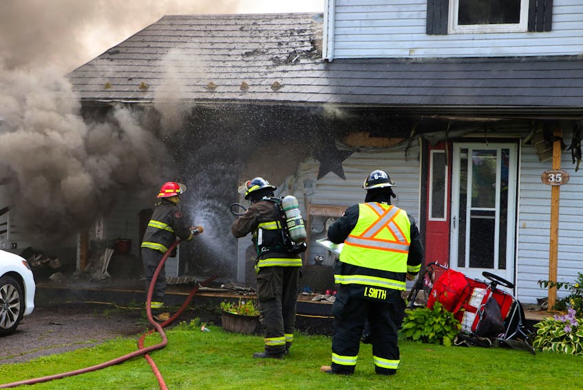 Amherst firefighters work to extinguish a blaze at 35 Elmwood Dr. on Tuesday morning. A woman and two children were displaced by the fire that caused extensive damage to the home. Tom McCoag-Town of Amherst photo