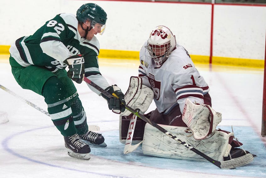 Saint Mary's Huskies goaltender Eric Brassard makes a save on UPEI Panthers forward Jesse Sutton during Wednesday's AUS quarter-final playoff game at the Dauphinee Centre. RYAN TAPLIN • THE CHRONICLE HERALD