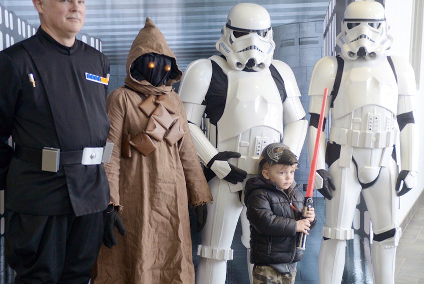 Shamus Driscoll brought his own mask and lightsaber to get a picture with Star Wars characters during Stratford Winter Famfest Fun Fair. The characters are members of the Atlantic Squad of the Canadian Garrison’s 501st Legion. MITCH MACDONALD/THE GUARDIAN