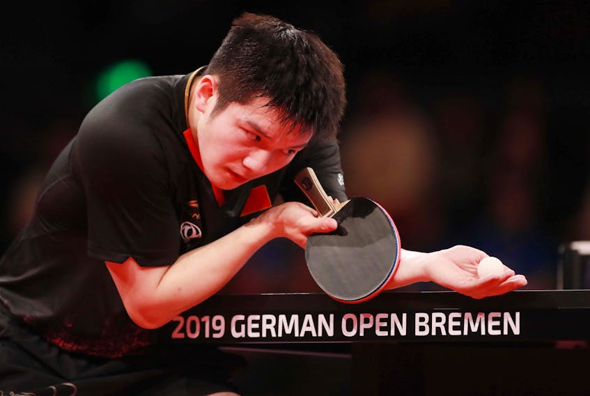 Fan Zhendong serves in this photo from the International Table Tennis Federation.