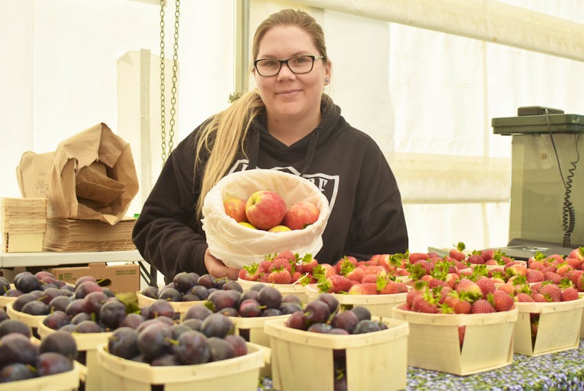Morgan Heckbert, an employee of Red Mountain Farm had fresh plums and strawberries for sale at the New Glasgow Farmer’s Market.