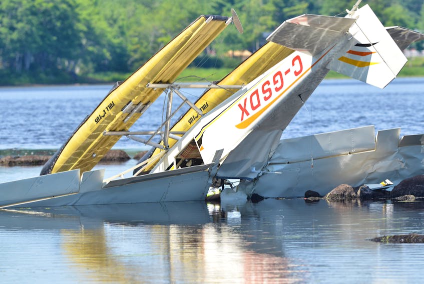 A floatplane lays upside down in New Germany Lake in New Germany on Wednesday. The floatplane crashed into the lake on Tuesday after it clipped power lines when attempting to land, RCMP said.