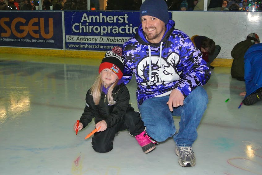 Brad Delahunt and his daughter Marissa were among those to enjoy the night at the Family First New Year’s Eve celebration at the Amherst Stadium on Dec. 31.