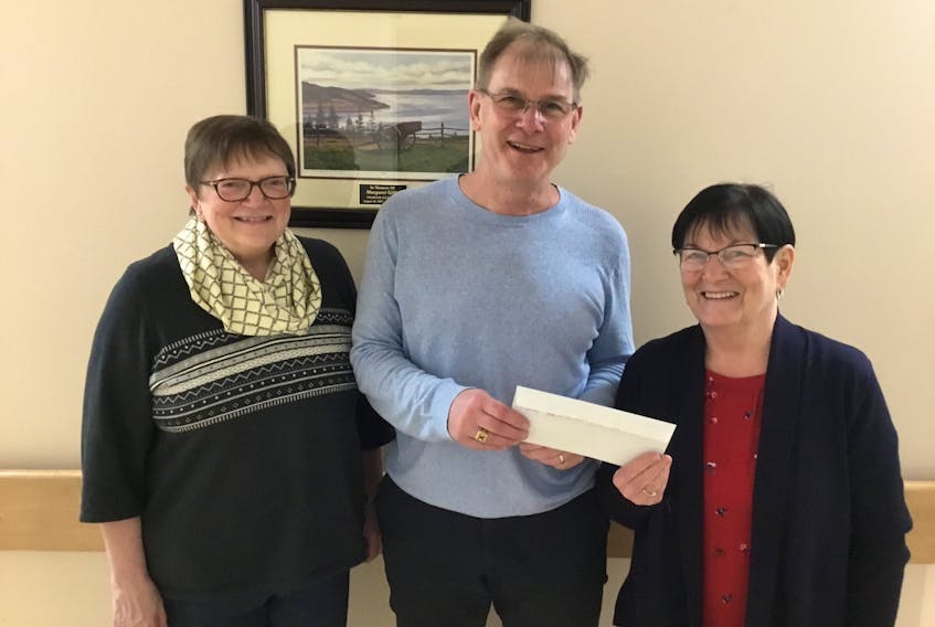 Marg Robertson (left) and Linda Howell (right) representing Our Lady of Fatima CWL, are pictured presenting Tom McNeil, Social Worker at the Cape Breton Regional Hospital Cancer Centre, with a cheque for $900 for the Patient Comfort Fund. The money represents proceeds from the CWL Annual Tulip Luncheon and Card Party.
