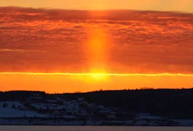 A beam of light from the rising sun cast a warm tangerine glow on a cold-looking Sydney Harbour.  Denise Clarkson's timing was perfect, and the photo is mesmerizing.
