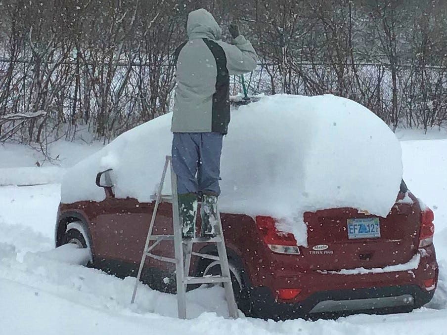 Karen Watson's job was to take this fun photo of her husband, Bob, cleaning off the car following a significant "dump" in Kentville, NS, earlier this month.  No word on whether Bob thought his job was fun!  There was so much snow he decided that a ladder would make the job a little easier.  Did the Watsons' wait until the plow was nearby?